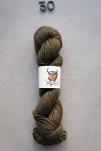 Load image into Gallery viewer, Brown skein of yarn with a label on a gray background