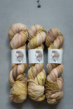 Load image into Gallery viewer, Three skeins of multicolored yarn with labels on a gray background