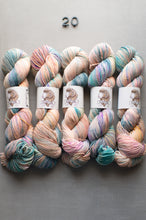 Load image into Gallery viewer, Five skeins of multicolored yarn on a gray background