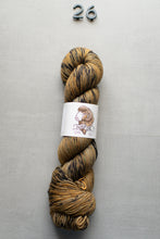 Load image into Gallery viewer, Yarn skein with a label on a gray background