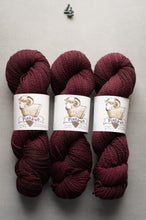 Load image into Gallery viewer, Three skeins of dark red yarn with labels on a gray background