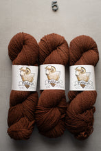 Load image into Gallery viewer, Three skeins of brown yarn with 'Pishkaun' labels on a gray background