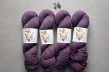 Load image into Gallery viewer, Four skeins of purple yarn with labels on a gray background