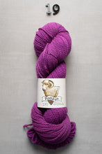 Load image into Gallery viewer, Purple skein of yarn with a label on a gray background