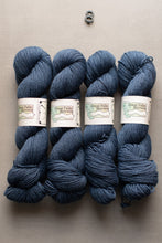 Load image into Gallery viewer, Four skeins of blue yarn with labels on a neutral background