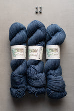 Load image into Gallery viewer, Three skeins of blue yarn with labels on a gray background