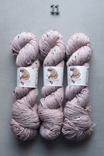 Load image into Gallery viewer, Three skeins of pink yarn with labels on a gray background