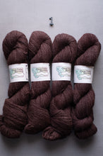 Load image into Gallery viewer, Four skeins of brown yarn with labels on a gray background