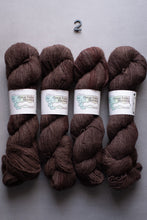 Load image into Gallery viewer, Four skeins of brown yarn with labels on a gray background