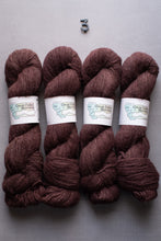 Load image into Gallery viewer, Four skeins of brown yarn with labels on a gray background