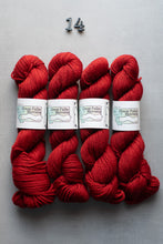 Load image into Gallery viewer, Four skeins of red yarn with labels on a gray background
