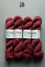 Load image into Gallery viewer, Four skeins of red yarn with labels on a gray background