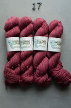 Load image into Gallery viewer, Four skeins of red yarn with labels on a gray background