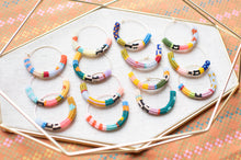 Load image into Gallery viewer, Set of colorful beaded bracelets on a decorative surface