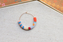 Load image into Gallery viewer, Colorful beaded hoop on a textured fabric background