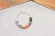 Load image into Gallery viewer, Colorful beaded hoop on a textured fabric background