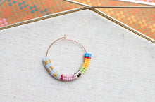 Load image into Gallery viewer, Colorful beaded necklace on a textured fabric background