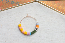 Load image into Gallery viewer, Colorful beaded hoop on a textured surface