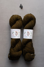 Load image into Gallery viewer, Two skeins of dark brown yarn with labels on a gray background