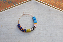 Load image into Gallery viewer, Colorful beaded hoop on a textured surface with a patterned border