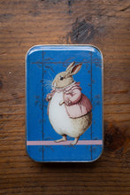 Load image into Gallery viewer, Tin box with a rabbit illustration on a wooden surface
