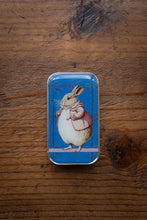 Load image into Gallery viewer, Small tin box with a rabbit illustration on a wooden surface
