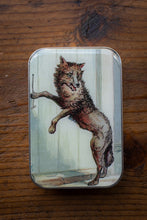 Load image into Gallery viewer, Tin box with a wolf design on a wooden surface