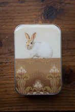 Load image into Gallery viewer, Small tin box with a rabbit illustration on a wooden surface