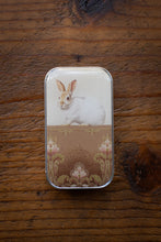 Load image into Gallery viewer, Small tin box with a rabbit illustration on a wooden surface