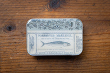 Load image into Gallery viewer, Decorative tin box with fish illustration on a wooden surface