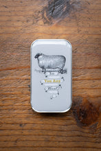Load image into Gallery viewer, Small metal tin with a sheep illustration on a wooden surface