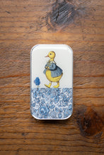 Load image into Gallery viewer, Small tin with a duck illustration on a wooden surface