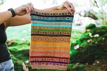 Load image into Gallery viewer, Person holding a colorful knitted item with a natural background