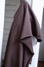 Load image into Gallery viewer, Brown fabric draped over a white door