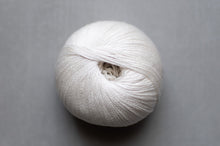 Load image into Gallery viewer, White skein of yarn on a gray background