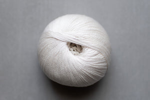 White skein of yarn on a gray background