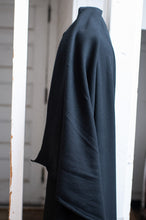 Load image into Gallery viewer, Dark blue sweater draped over a white door frame