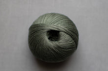 Load image into Gallery viewer, Ball of green yarn on a gray background