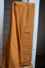Load image into Gallery viewer, Mustard yellow fabric draped over a white door frame
