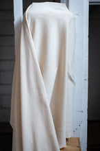 Load image into Gallery viewer, White fabric draped over a white wooden frame against a dark background