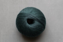 Load image into Gallery viewer, Teal skein of yarn on a light gray background