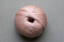 Load image into Gallery viewer, Ball of pink yarn on a gray background