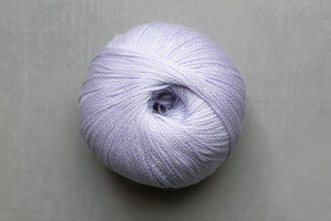 Ball of light purple yarn on a gray background