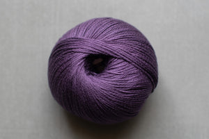 Purple yarn ball on a gray background