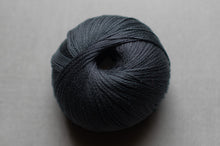 Load image into Gallery viewer, Ball of dark blue yarn on a gray background