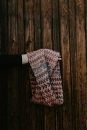 Knitted scarf with a pattern against a wooden background