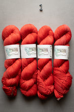 Load image into Gallery viewer, Four skeins of red yarn with labels on a gray background