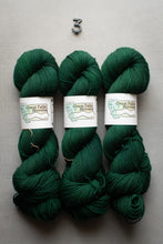 Load image into Gallery viewer, Three skeins of green yarn with labels on a gray background