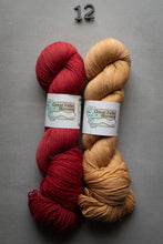Load image into Gallery viewer, Two skeins of yarn, one red and one beige, on a gray background with 'Great Falls Yarn' labels.