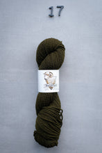 Load image into Gallery viewer, Olive green skein of yarn with a label on a gray background